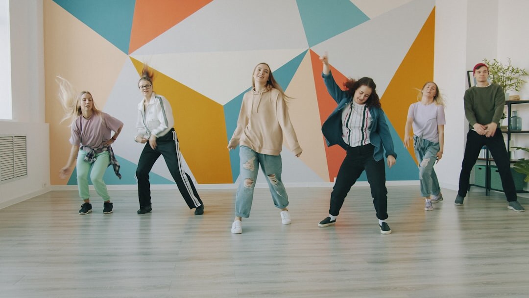 Group of diverse seniors dancing together in a bright studio