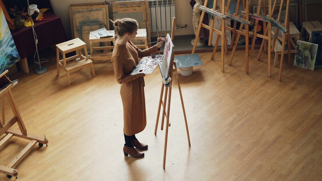 Senior woman painting on a canvas in an art studio